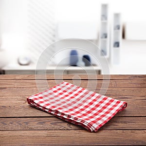 Kitchen towel on empty wooden table. Napkin close up top view mock up for design. Kitchen rustic background.