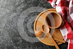 Kitchen towel and wooden dishes on black smokey background
