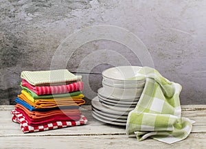 Kitchen towels with dishes on wooden table photo