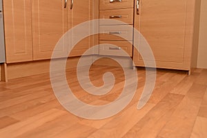 Kitchen units and wooden floor photo