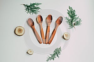 Kitchen utencils set for takeaway business: wooden recycling eco spoon, fork on white side view