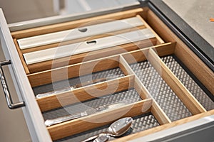 Kitchen utensil cutlery drawer organizer tray with simple set of tools, minimalist order. Open drawer with different