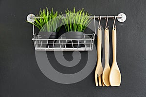 Kitchen utensil hang on black wall