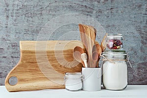 Kitchen utensils background with a wooden cuting board, home kitchen concept