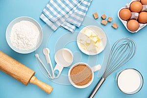 Kitchen utensils and baking ingredients on blue background photo