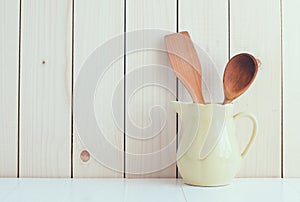 Kitchen utensils in ceramic jug