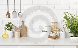 Kitchen utensils, cooking ingredients and kitchenware on white counter table