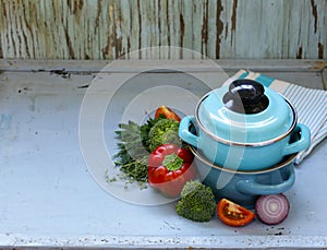 Kitchen utensils, cooking pans on a wooden background