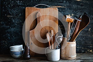 Kitchen utensils and dishware on wooden shelf