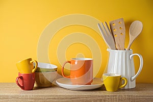 Kitchen utensils and dishware on wooden shelf. Autumn kitchen interior background