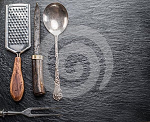 Kitchen utensils on a graphite background.