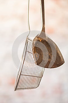 Kitchen utensils hanging outside, ready to be used with grill, rustic iron cooking set