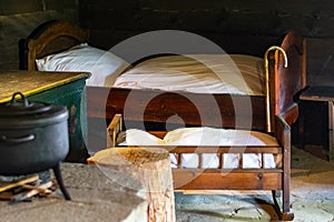 Kitchen utensils in the interior of old traditional rural wooden house.