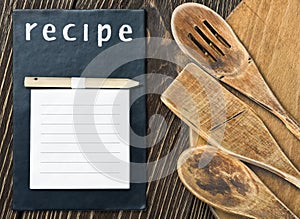 Kitchen utensils and a notepad to write a recipe