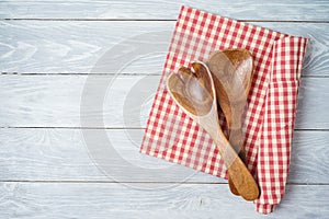 Kitchen utensils with red checked tablecloth on rustic wooden table Kitchen, cooking or baking mock up background for design