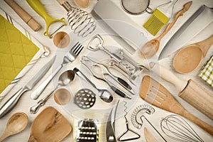 Kitchen utensils set on wooden texture background