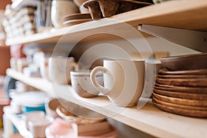 Kitchen utensils on shelf in pottery workshop