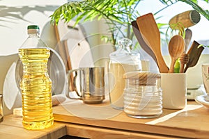 Kitchen utensils, sunflower oil, flour on wooden table in pantry