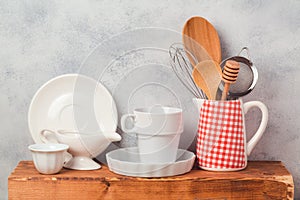 Kitchen utensils and tableware on wooden board