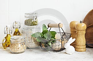 Kitchen utensils, tools and dishware on on the background white tile wall