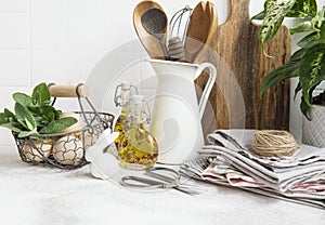 Kitchen utensils, tools and dishware on on the background white tile wall