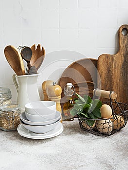 Kitchen utensils, tools and dishware on on the background white tile wall