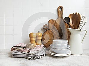 Kitchen utensils, tools and dishware on on the background white tile wall