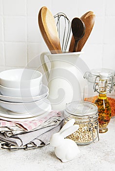 Kitchen utensils, tools and dishware on on the background white tile wall