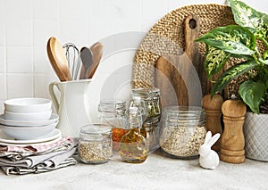 Kitchen utensils, tools and dishware on on the background white tile wall