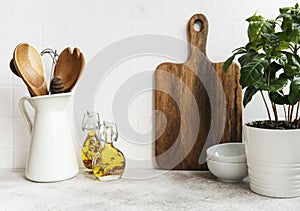 Kitchen utensils, tools and dishware on on the background white tile wall