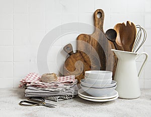 Kitchen utensils, tools and dishware on on the background white tile wall