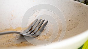 The kitchen utensils in the wash basin need to be washed. A pile of dirty dishes in the kitchen sink. Kitchen utensils need