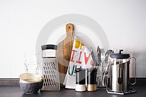 Kitchen utensils on a white tile background. Kitchen interior, background