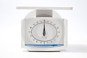 Kitchen weighing scale over white background