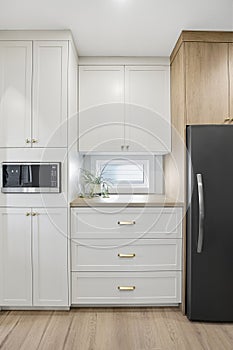 Kitchen with white cabinets and a black refrigerator