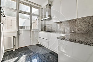 a kitchen with white cabinets and granite counter tops