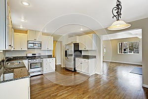 Kitchen with white cabinets and granite tops