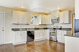 Kitchen with white cabinets and granite tops