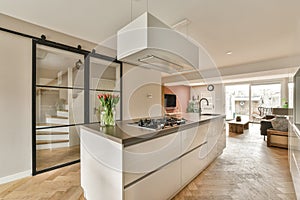 a kitchen with white cabinets and a large counter top