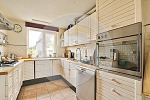 a kitchen with white cabinets and a stainless steel refrigerator