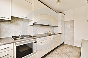 a kitchen with white cabinets and a stove