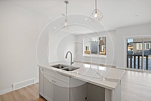 Kitchen with a white countertop and two sinks