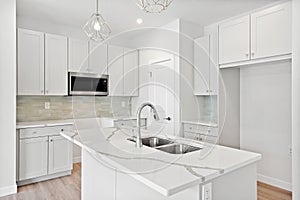 Kitchen with a white countertop and a white sink