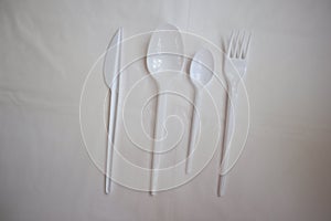 Kitchen white plastic knife, fork and spoons