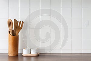 Kitchen with white tiles on the wall. Kitchen tools.