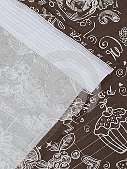 kitchen window curtains made of chocolate-colored cotton fabric, isolated