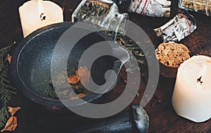 Kitchen witchery - making magickal spice blend for a spell. Dried herbs and spices mixed in mortar photo