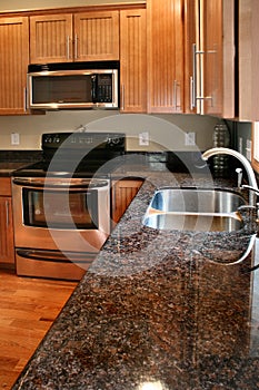 Kitchen wood cabinets black and stainless stove