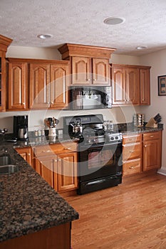 Kitchen wood cabinets black stove