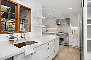 a kitchen with a wood window over a white counter top